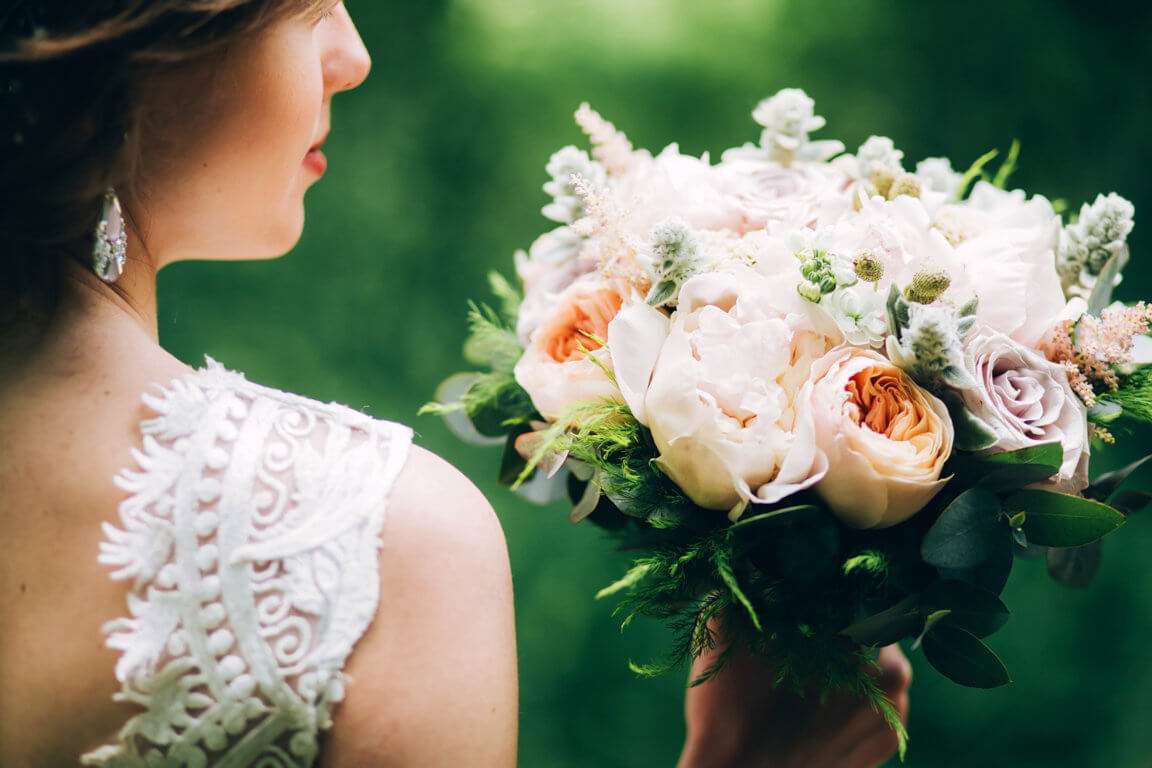 optimize-tender-bride-holding-wedding-bouquet-bride-nature-with-bouquet-peonies.jpg